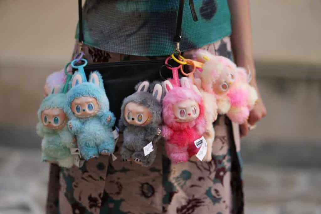PARIS, FRANCE - JUNE 12: Close-up detail view of seven Labubu monsters / charms / dolls / plus from "Big Into Energy" collection : Loyalty, Happiness, Luck, Hope, Serenity, Love an Secret, during a street style fashion photo session, on June 12, 2025 in Paris, France. (Photo by Edward Berthelot/Getty Images)