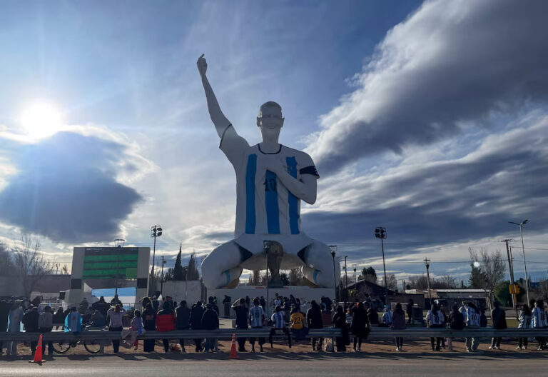 Argentines Celebrate World Cup Semi-Final Win Under Giant Messi Statue